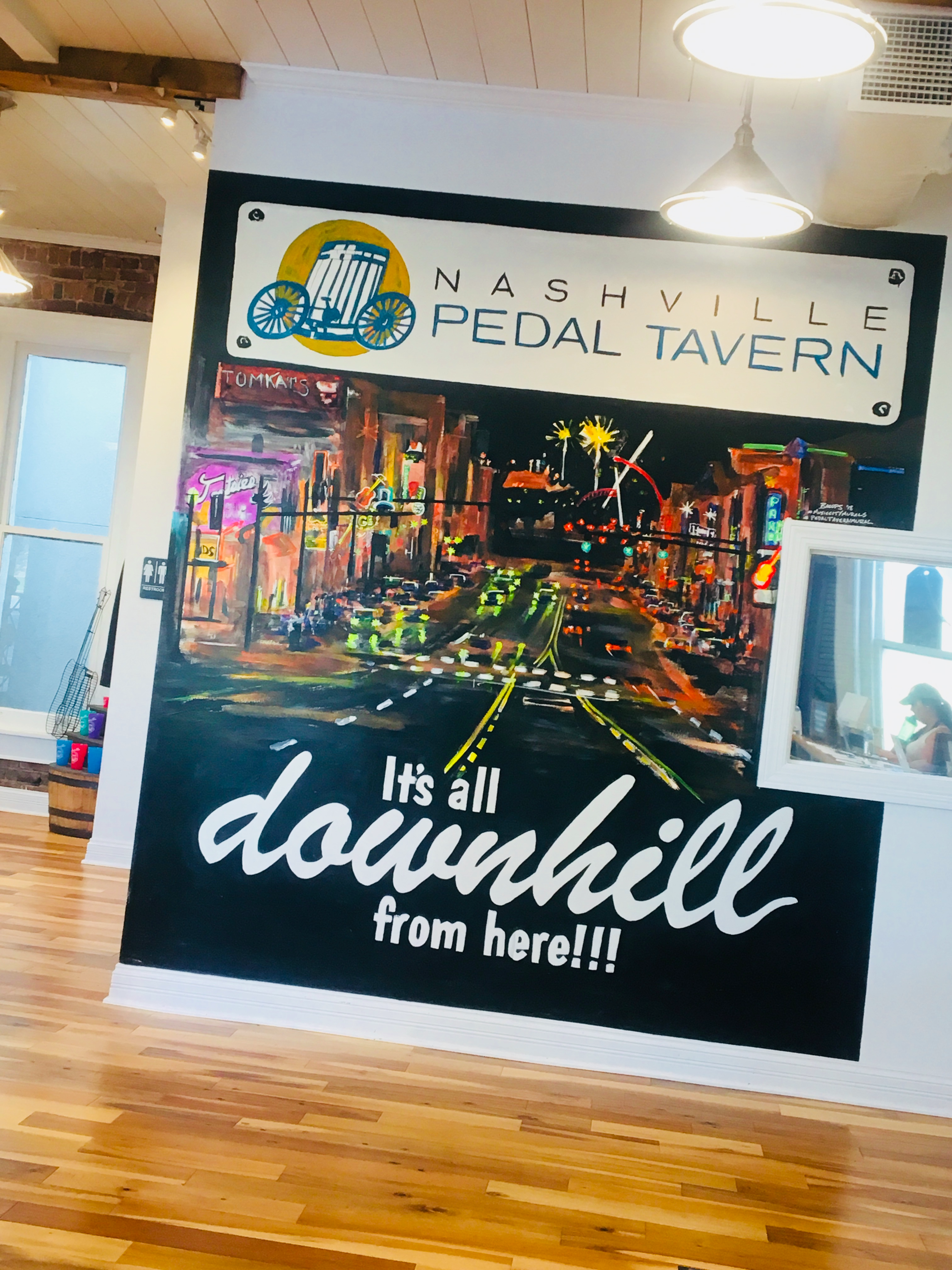 Poster in the Nashville Pedal Tavern office that reads "It's all downhill from here!!!"