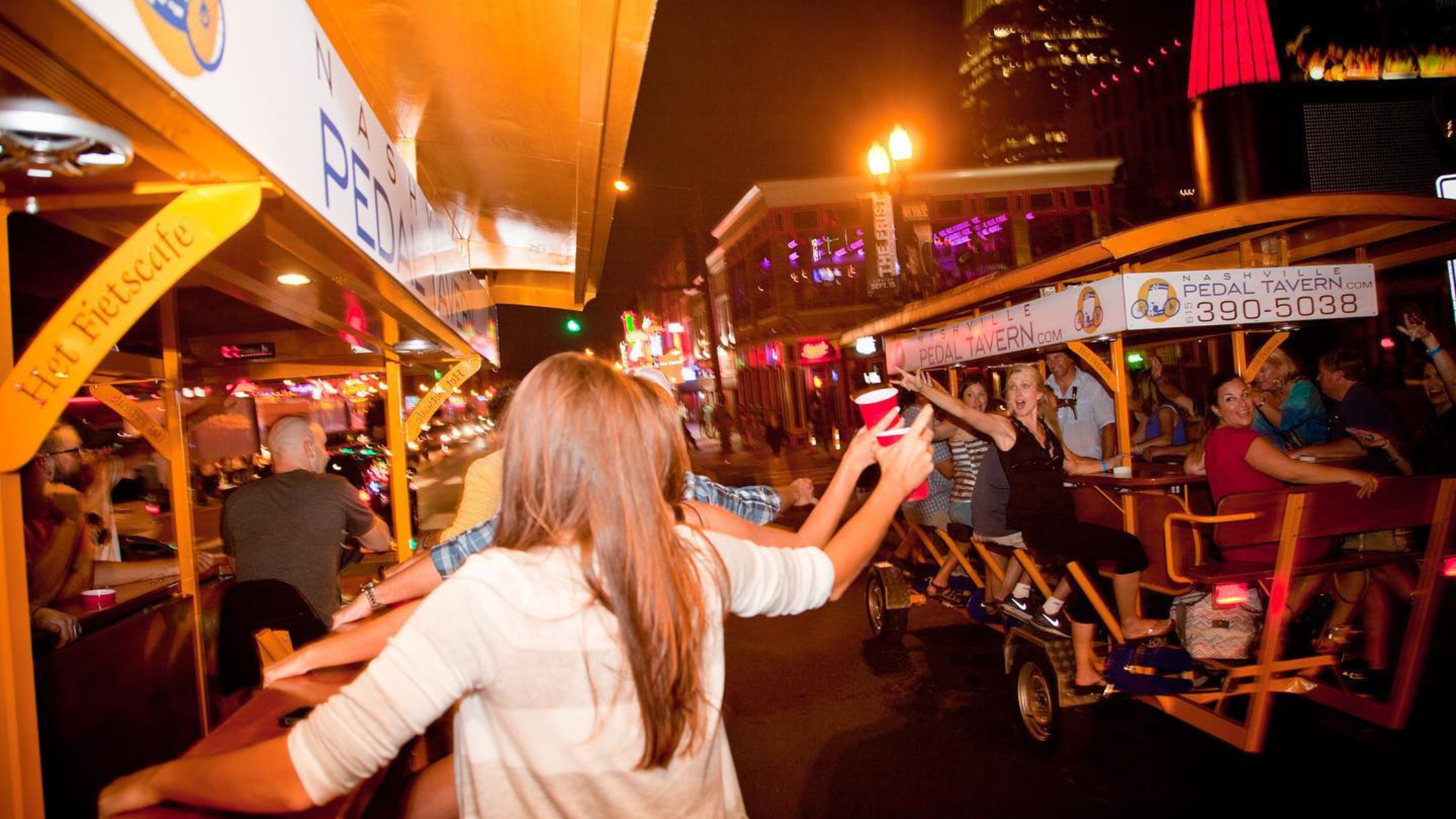 2 nashville pedal tavern bikes pedaling down broadway in nashville 