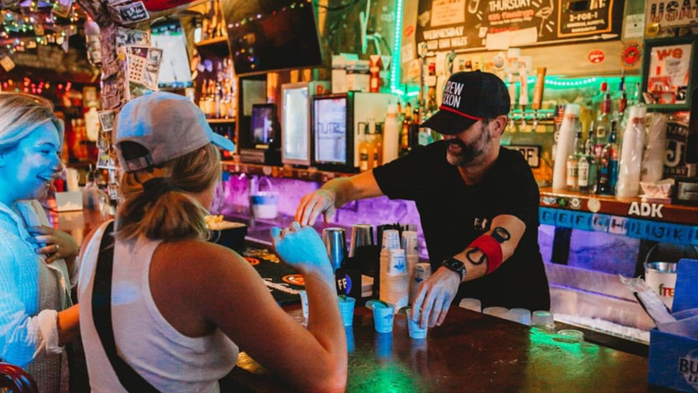 2 women being served drinks at a bar in downtown nashville