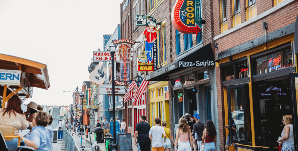 nashville pedal tavern on a brodway tour with the honky tonks and neon signs in the photo